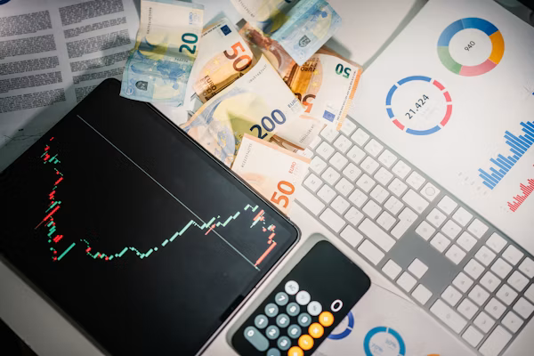 Calculator resting on a stack of currency